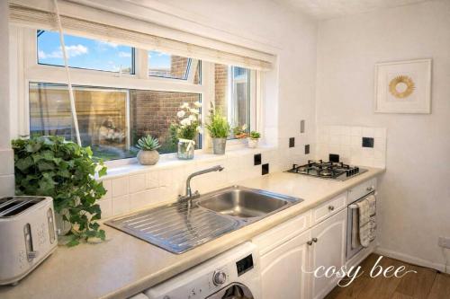a kitchen with a sink and a window at Freemantle Solent Lodge in Southampton