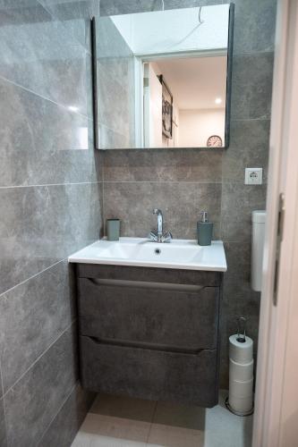 a bathroom with a sink and a mirror at Apartmani Prestige in Gornji Vakuf