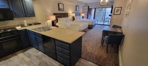 a living room with a kitchen and a living room with a bed at Park Plaza Resort - Park City, Ascend Collection Hotel in Park City