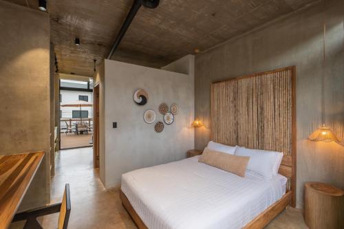 a bedroom with a white bed in a room at The Digital Nomad Den in Jacó