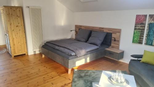 a bedroom with a bed and a couch in a room at Ferienwohnung Lottchen in Schwerin