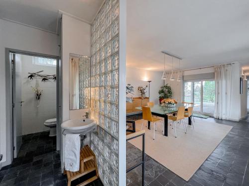 a kitchen and a dining room with a dining table at Casa das Rampas - Nature Retreat with Pool in Moledo