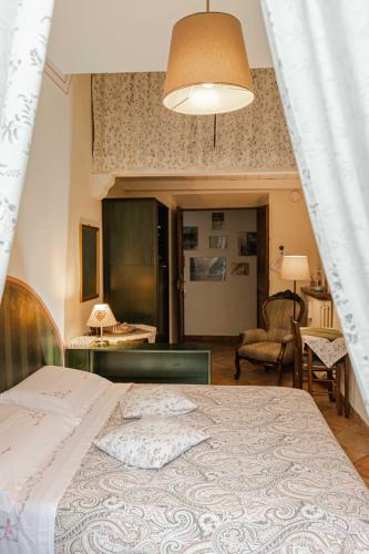 a bedroom with a bed and a living room at B&B Il Glicine Molare in Cremolino