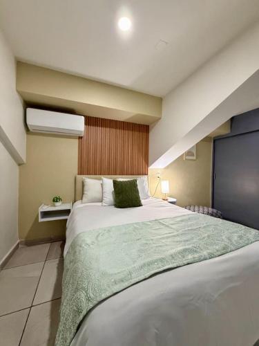 a bedroom with a large bed in a room at AR Suites 1 Centro de la ciudad in Zamora de Hidalgo