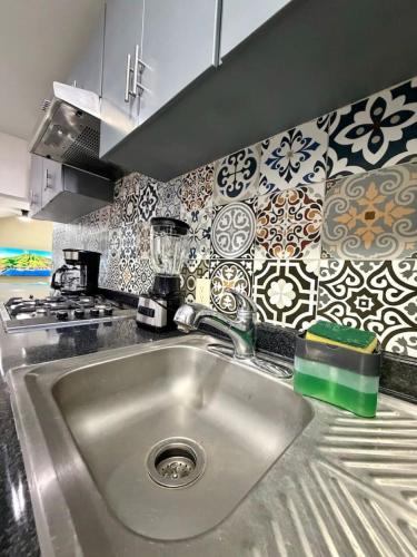 a kitchen counter with a sink in a kitchen at AR Suites 1 Centro de la ciudad in Zamora de Hidalgo