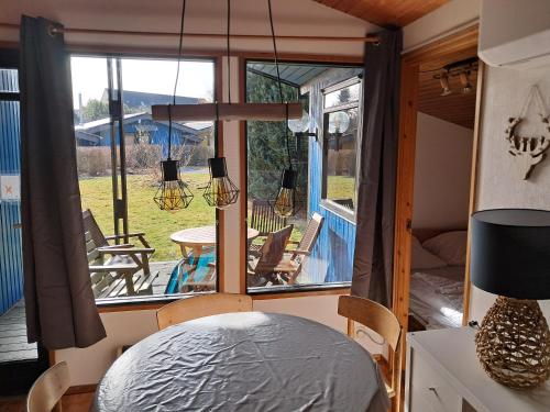 a room with a bed and a table and chairs at Wald Chalet Nr 4 in Kellenhusen