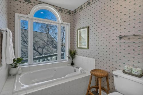 a bathroom with a tub and a window at Lakefront Retreat-Sunset Views in Prosperity