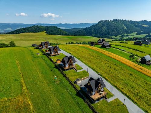 an aerial view of a farm with houses in a field at Osada Dursztyn- Przystanek Podhale in Białka Tatrzańska