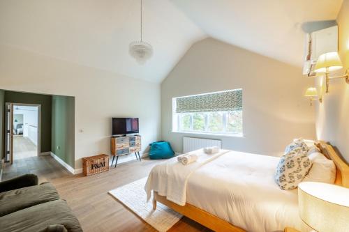 a bedroom with a large bed and a couch at Seahenge in Brancaster