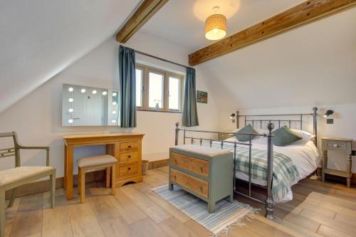 a bedroom with a bed and a desk and a chair at Wallower in Harpley