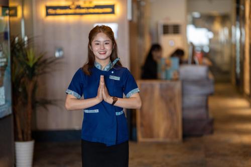 a woman standing in a room with her hands at The Snowbell Hotel & Spa at The Bridge in Phnom Penh