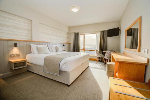 a hotel room with a bed and a desk at Beach Hotel & Restaurant in Downings