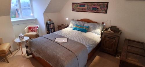 a bedroom with a bed and a table and a chair at Chez Jo in Lewes