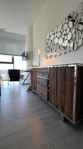a kitchen with a counter with plates on the wall at Hanza Tower Level XV Signature in Szczecin