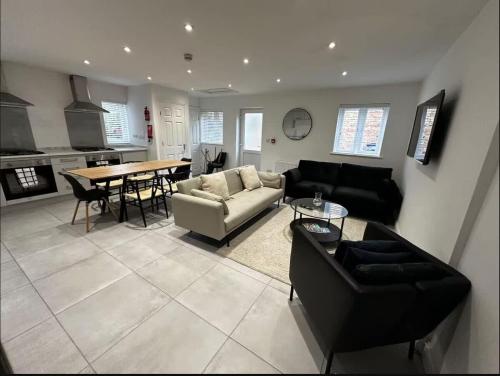 a living room with a couch and a table in it at Spacious 6-Bed Home With 4 Parking Spaces in Oxford