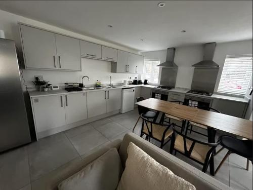 a kitchen with a couch and a table in a room at Spacious 6-Bed Home With 4 Parking Spaces in Oxford