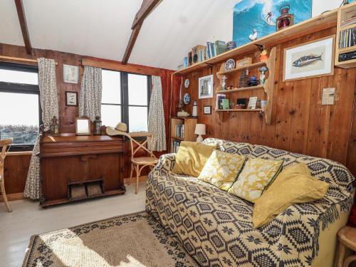 a living room with a couch and a table at The Cabin in Cawsand