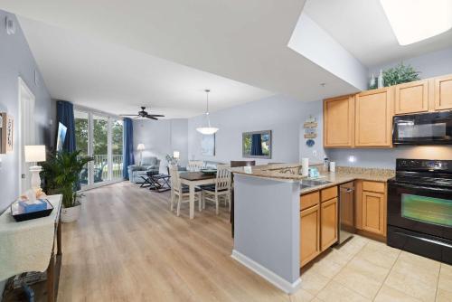 an open kitchen and living room with a dining room at 5 Star Resort 2BR 2 BATH King Suite Shuttle Pools Across from Beach 2208 in Destin