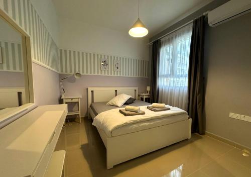 a small bedroom with a bed and a window at MyGuest Cornelius 70 , 1-Bedroom Luxury Apartment in Iskele