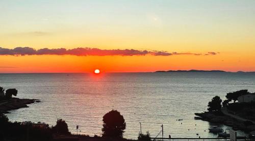 a sunset over a body of water with at Sunset Bay Casa in Dolac