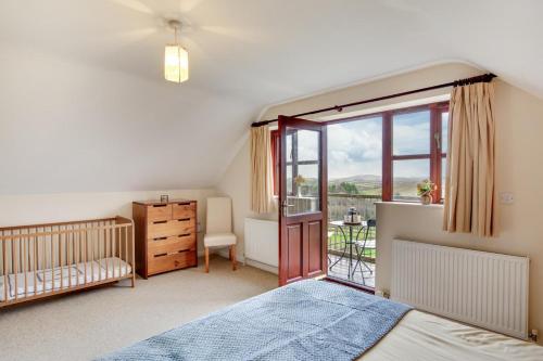 a bedroom with a bed and a window at 4 Bed in Upton Cross oc-j34643 in Upton