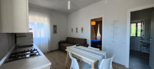 a kitchen and living room with a stove and a couch at Liberato Puglia Vacanze in Peschici