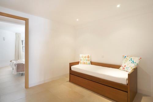 a bed in a room with a mirror at Golden Club Cabanas in Cabanas de Tavira