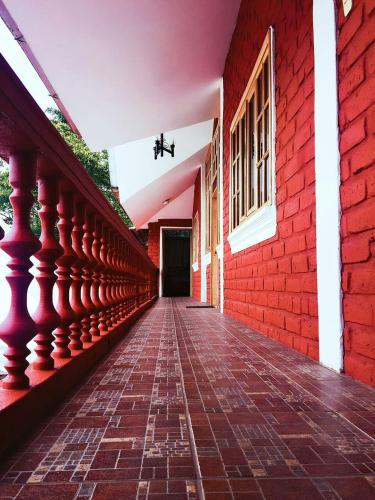 an empty hallway of a building with a red brick wall at Hosteria Don Elias in Puyo