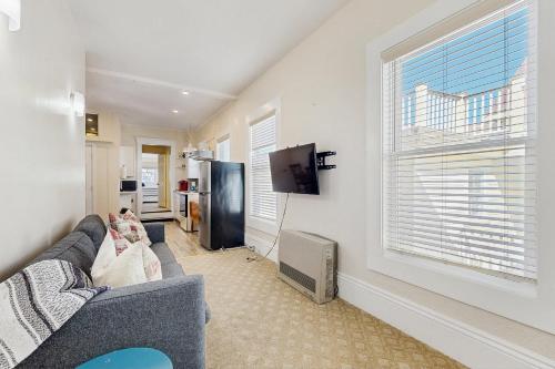 a living room with a couch and a large window at John Cabot #1 in Provincetown