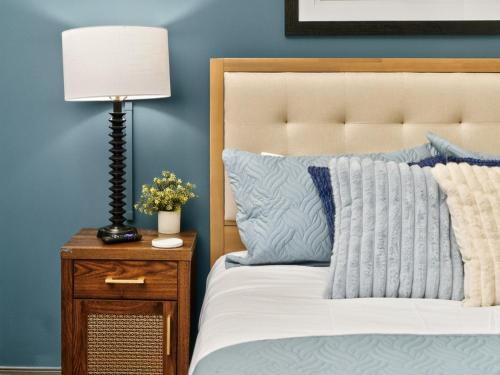 a bedroom with a bed and a lamp on a night stand at Spacious 1BR loft with flexible group sleeping in Dallas