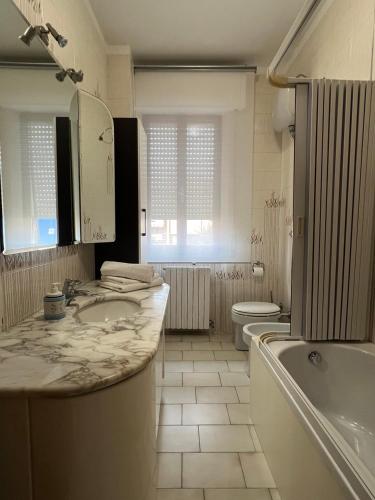 a bathroom with a sink and a tub and a toilet at Casa Camilla in Lido di Fermo