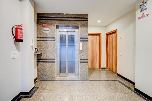 a hallway with a glass door in a building at Hotel Peridot with Free Airport Pickup in New Delhi