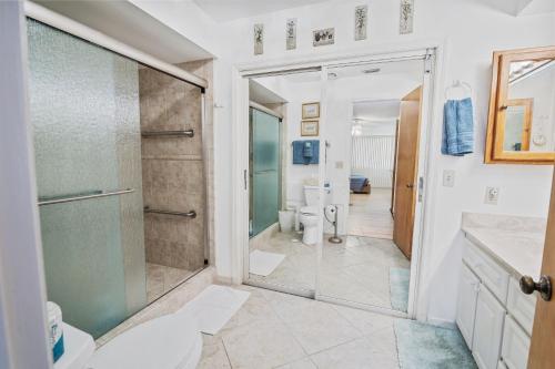 a bathroom with a shower and a toilet at Sea Woods Home 4205 in New Smyrna Beach