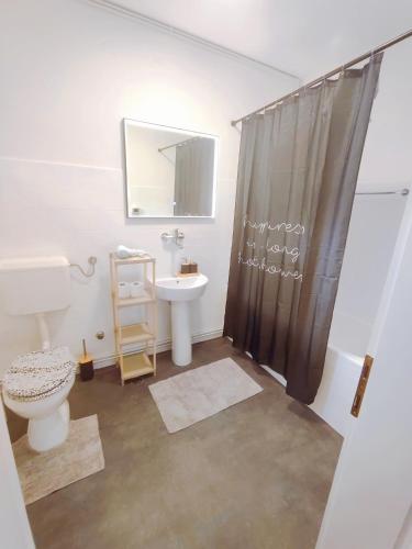 a bathroom with a sink and a toilet and a shower at Panorama Sky Apartment -11 min by walk to Old Town - Free Parking in Sarajevo