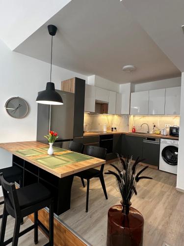 a kitchen and dining room with a table and chairs at B40 Green ApartRooms in Budapest