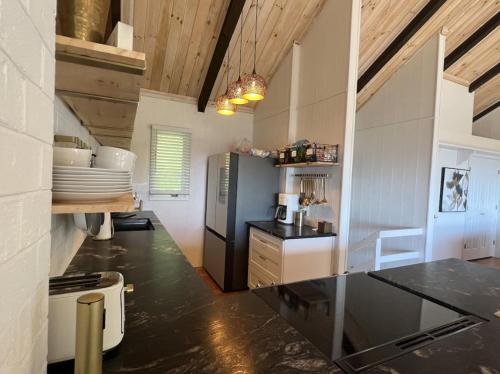 a kitchen with a black refrigerator and a counter at Remarkable Mountain Escape! Breathtaking Views & Pet Friendly! in Hillsville