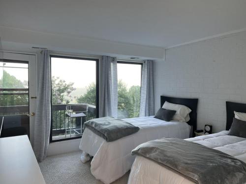 a bedroom with two beds and a balcony at Remarkable Mountain Escape! Breathtaking Views & Pet Friendly! in Hillsville