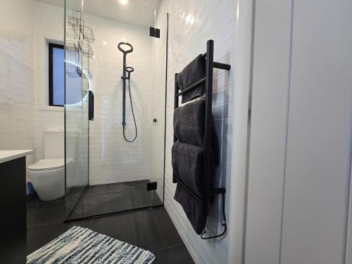 a bathroom with a shower and a glass door at Studio with amazing views in Russell