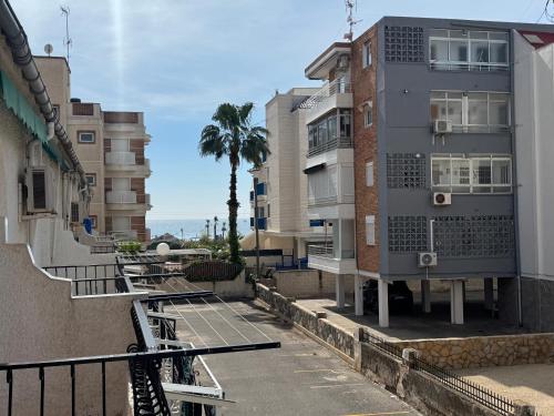 a building with a tennis court next to some buildings at Casita de Lucia in Santa Pola