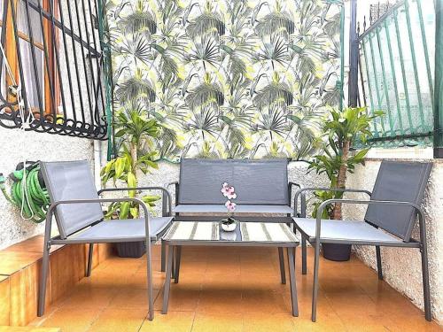 two chairs and a table on a balcony at Casita de Lucia in Santa Pola