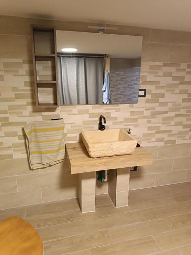 a bathroom with a sink and a mirror at Anime Salve B&B E-BIKE HOME RESTAURANT in Sala Baganza