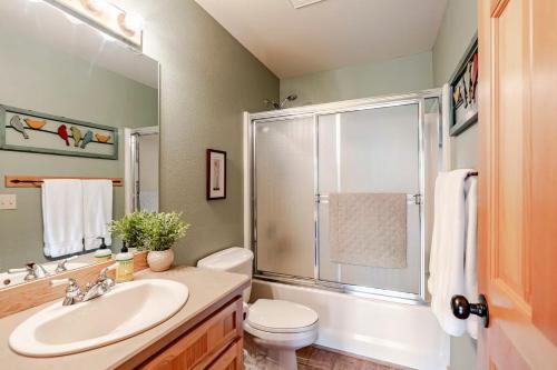 a bathroom with a toilet and a sink and a shower at 19th Hole Chalet at Eagle Crest in Redmond