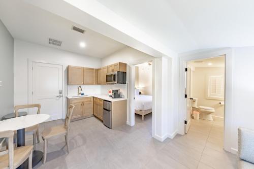 a kitchen and living room with a bed and a table at The Palmetto Inn in Boca Grande