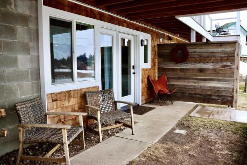 two chairs sitting on a patio next to a house at Charming 1 bedbath Suite in waterfront Cottage in Somers