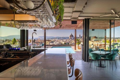 a bar with a view of a pool at The Social Hub Florence Lavagnini in Florence