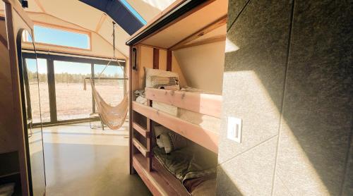 an interior view of a tiny house at Backland Luxury Nature Resort in Williams