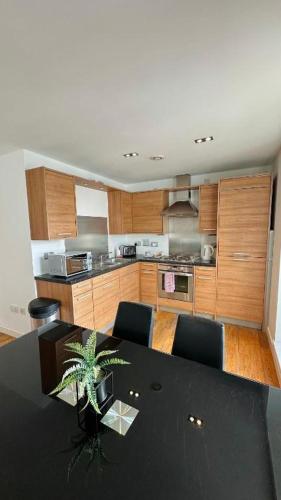 a kitchen with a dining room table with a plant at Britannia Apartments in Edinburgh