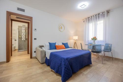 a bedroom with a bed and a table in it at PRESTIGE Apartments - Blue Serenity in Verona