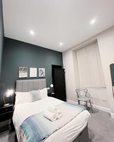 a bedroom with a bed with two towels on it at Central Leith Suite in Edinburgh