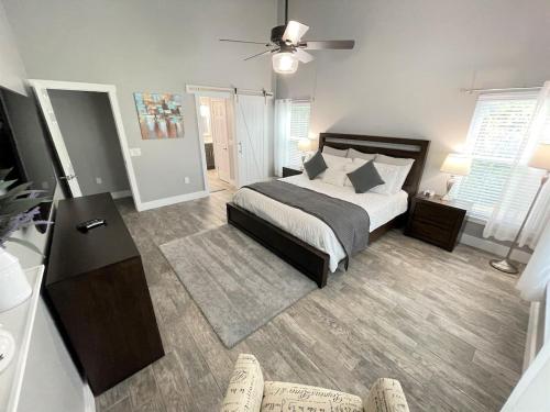 a bedroom with a bed and a living room at Phenomenal 7BR 4 Master Suites Southeast Pool Hot Tub Gas BBQ 2 Miles to Disney in Orlando